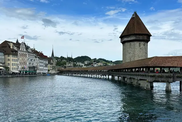 Chapel Bridge and its stone water tower in Lucerne, Switzerland, seen from across the water